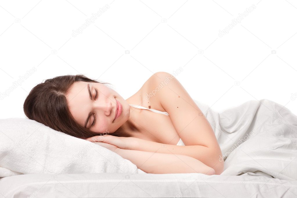 Beautiful woman lying down in bed