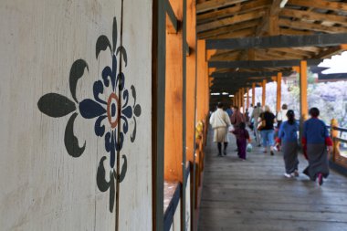 Bhutanese walk across the bridge of the Punakha Dzong (Bhutan) clipart