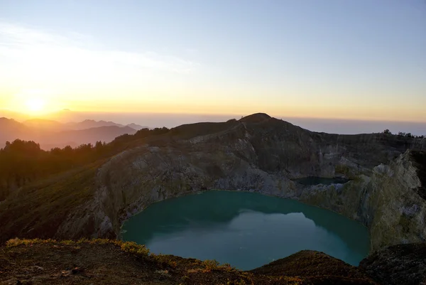 stock image Sunrise on top of the Kelimutu vulcano with a view on the 2 lakes