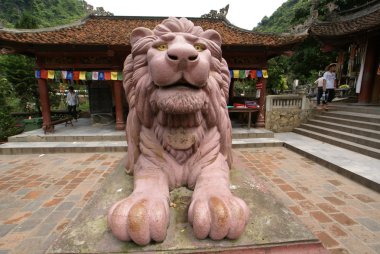 Statue of a lion in the Perfume Pagoda in Vietnam clipart