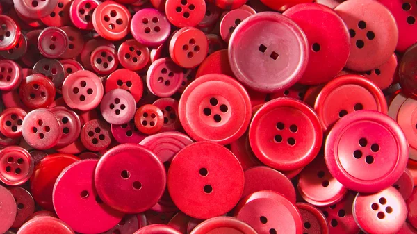 Röda knappar, små och stora Stockfoto