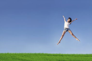 Excited woman jumping over blue sky clipart