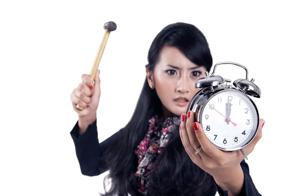 Angry businesswoman ready to hit an alarm clock — Stock Photo, Image