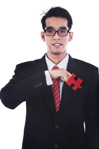Homme d'affaires avec un morceau de puzzle — Photo