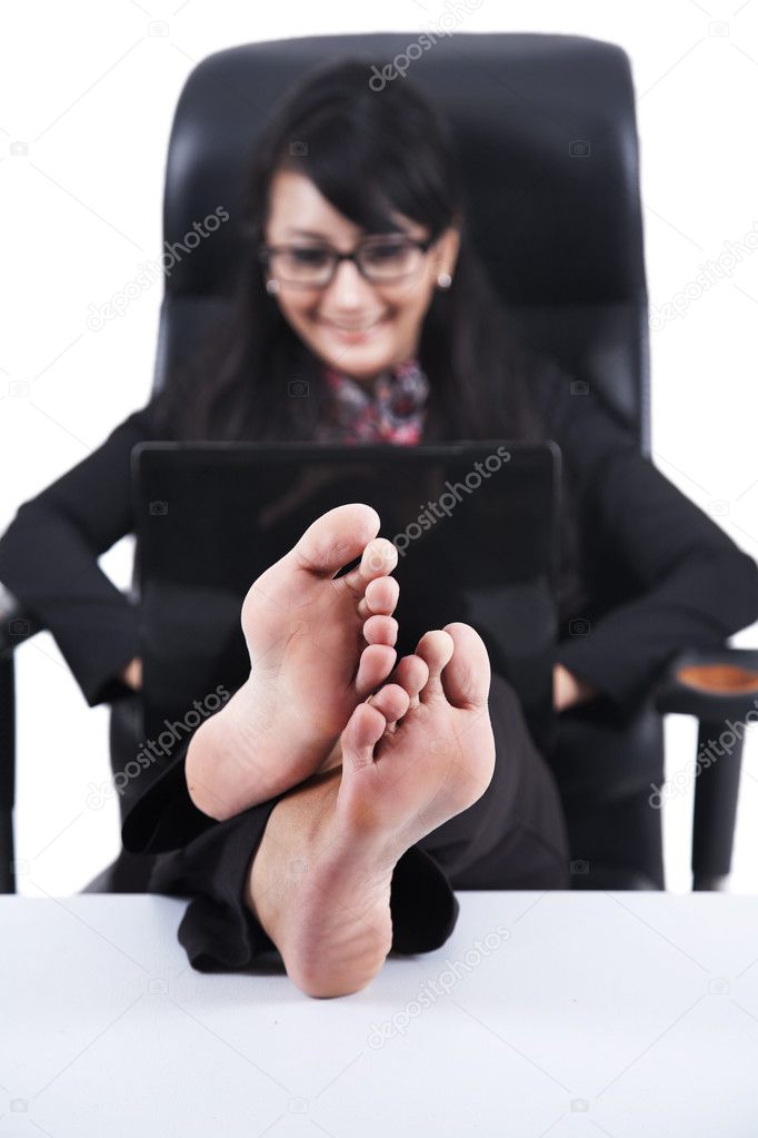 Asian businesswoman with Feet Up on a desk
