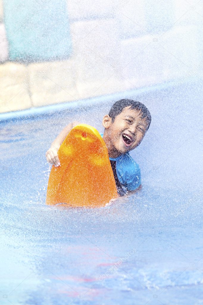 Happy asian kid at swimming pool