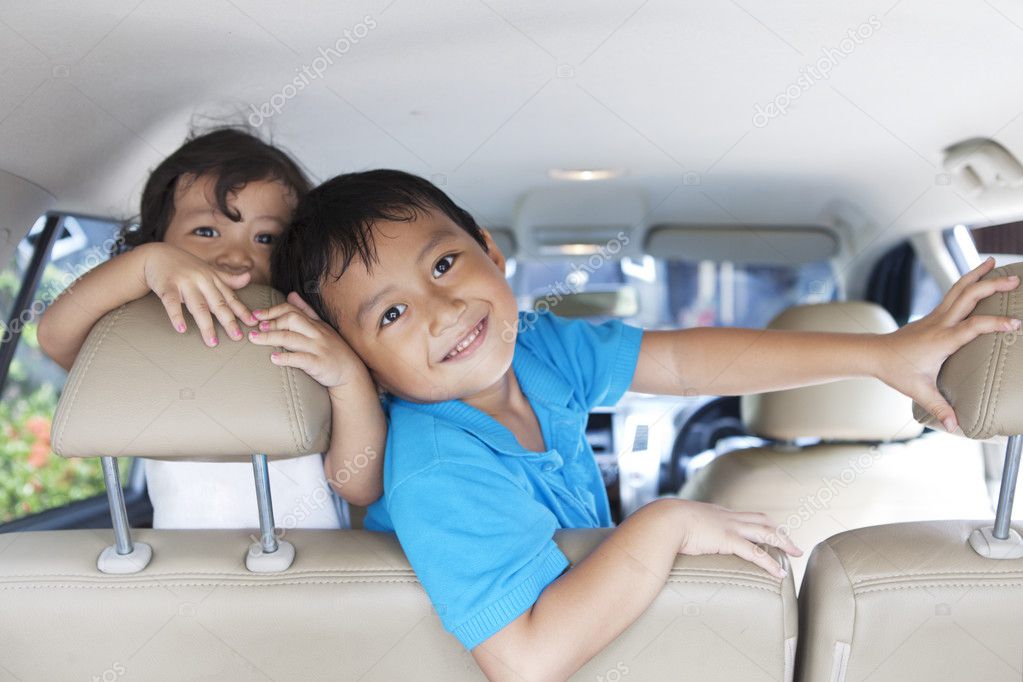 Happy siblings in the car