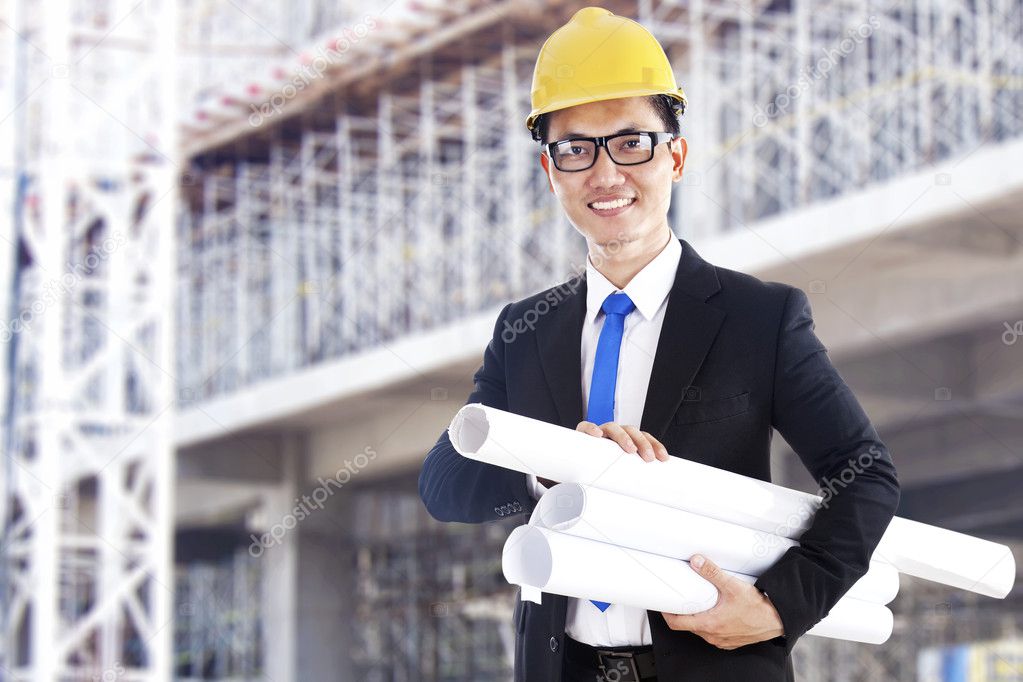 Asian developer with blueprints