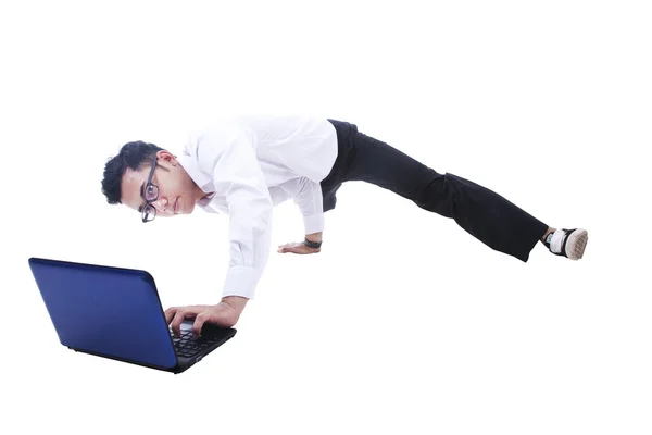 Businessman breakdancing while using laptop — Stock Photo, Image