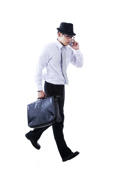 Businessman walks while calling — Stock Photo, Image
