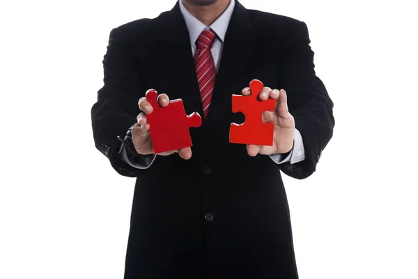 Businessman with pieces of puzzle — Stock Photo, Image