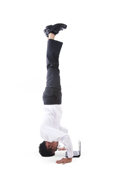 Businessman handstands with laptop — Stock Photo, Image