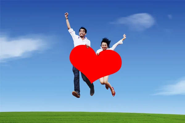 Couple sautant avec forme de coeur — Photo