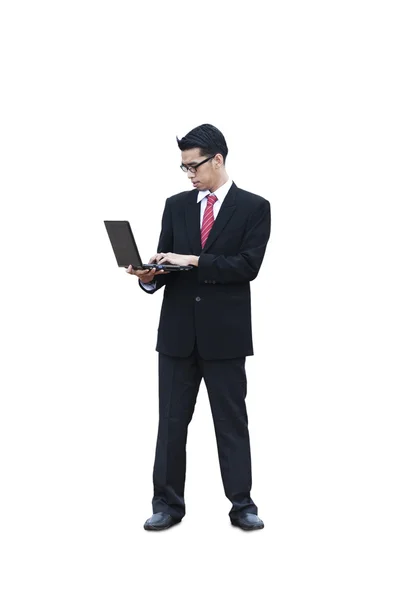 Standing businessman using laptop — Stock Photo, Image