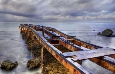 Old rusty pier in a cloudy day clipart