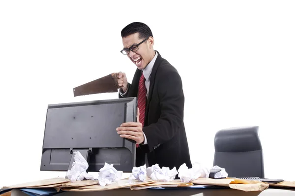 Frustrated businessman sawing his computer — Stock Photo, Image