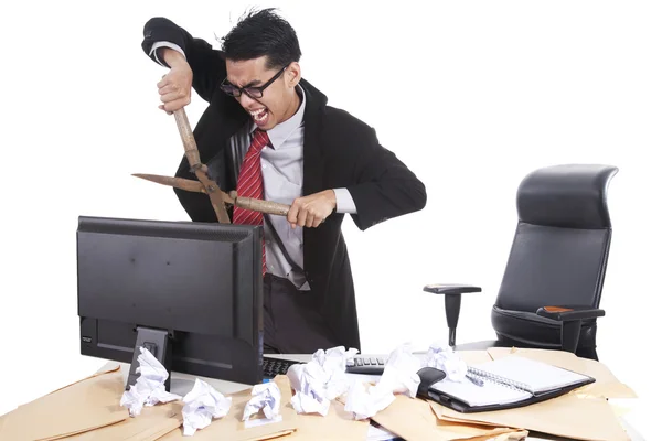 Mad businessman cutting computer — Stock Photo, Image