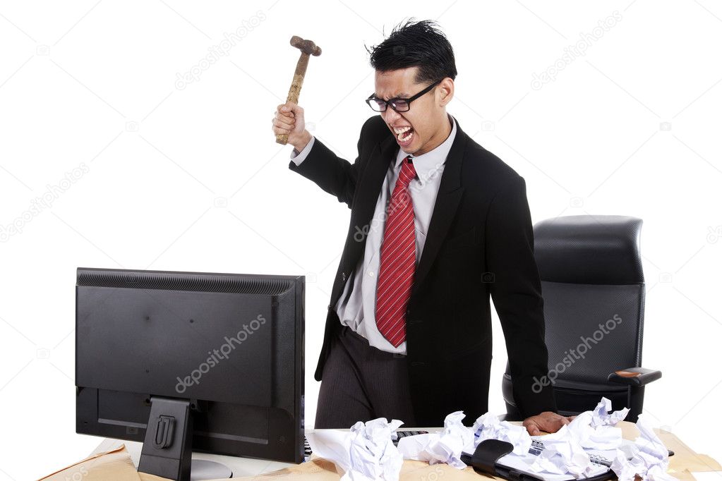 Mad businessman hitting his computer