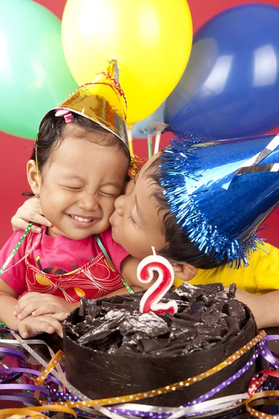 Brother kisses his sister on her birthday — Stock Photo, Image