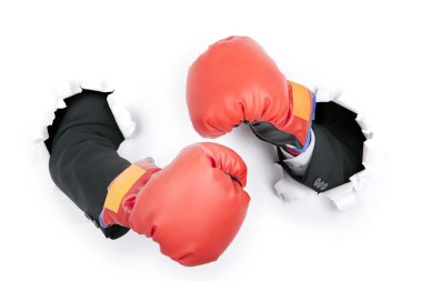 Businessman's hand in fight position wearing boxing gloves clipart