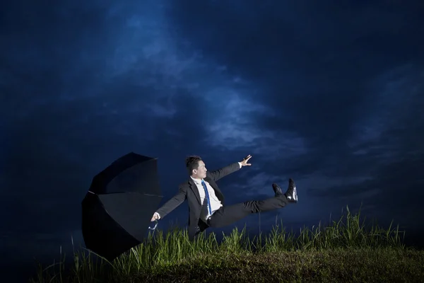 Businessman falling down in a cloudy day — Stock Photo, Image