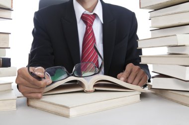 Businessman with glasses and books clipart