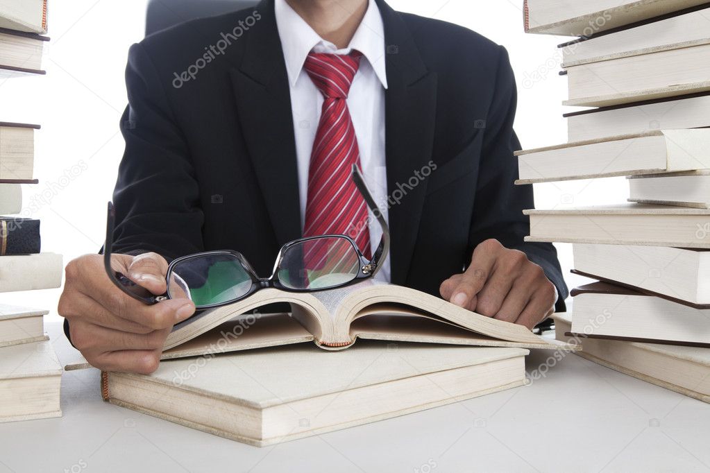 Businessman with glasses and books