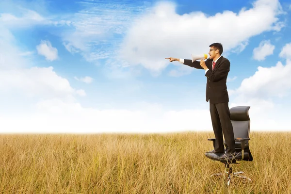 Businessman shouts using megaphone — Stock Photo, Image