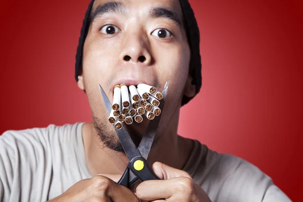 Smoker with scissor and lots of smokes — Stock Photo, Image
