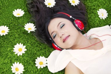 Beautiful woman listens to music outdoor clipart