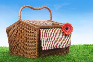 Picnic basket shot outdoor over green grass clipart