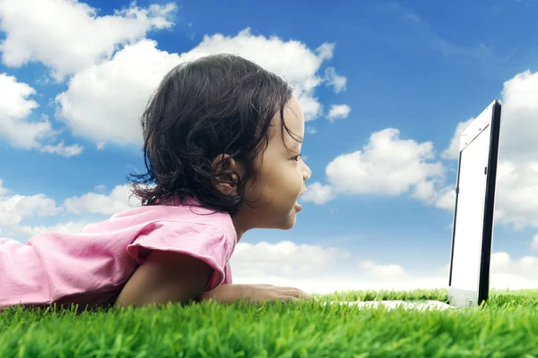 Kid with laptop in meadow — Stock Photo, Image