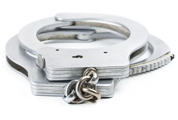 Photo of a pair of handcuffs isolated on a white background — Stock Photo, Image