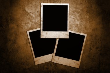 Aged photo frames on grunge background clipart