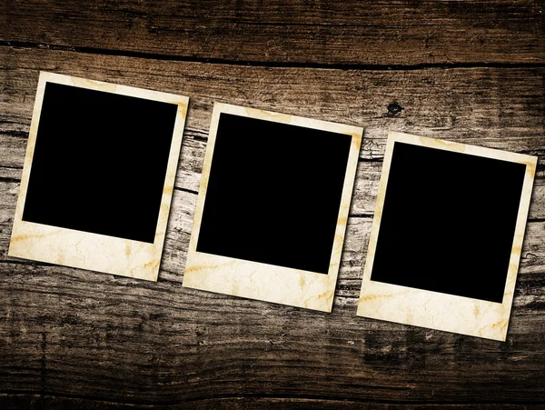 Grunge vintage photo frames on a wood — Stock Photo, Image