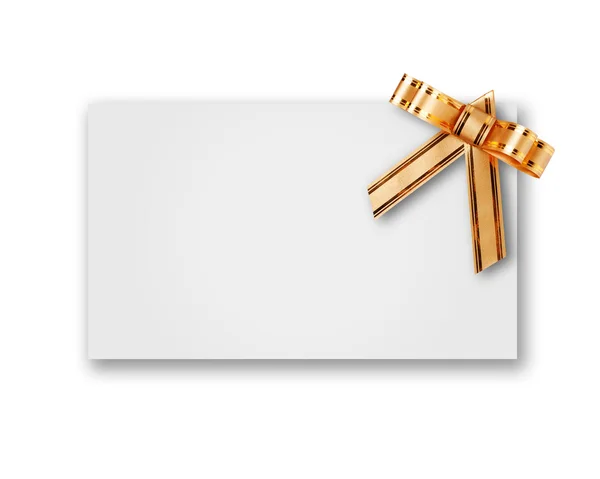 Blank postcard tied with a bow of golden ribbon — Stock Photo, Image