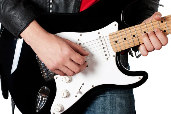 Young guy in leather jacket playing electric guitar — Stock Photo, Image