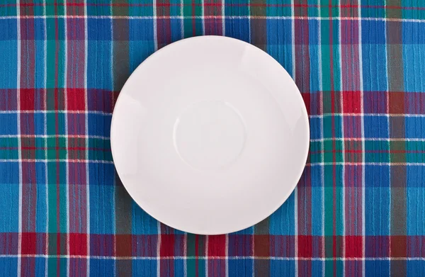 stock image The plate on checkered table cloth