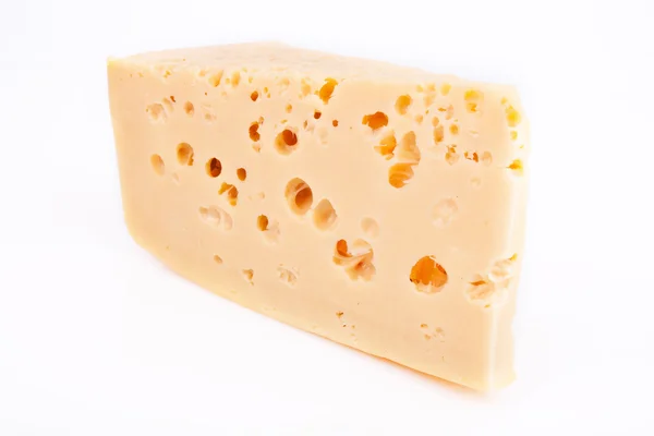 Pedazo de queso sobre un fondo blanco — Foto de Stock