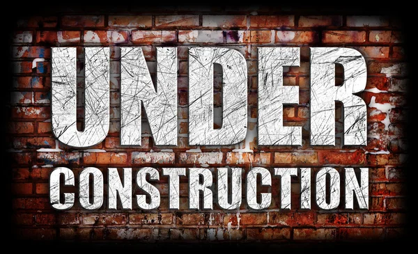Under Construction on brick wall — Stock Photo, Image
