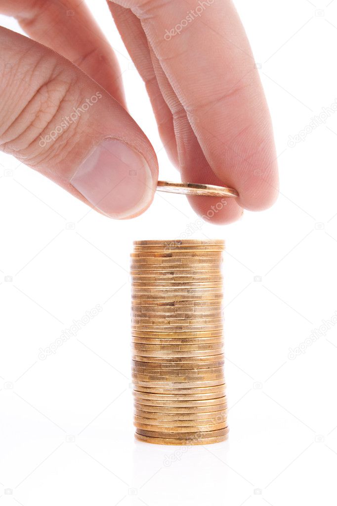 Stack of golden coins with reflection and hand with coin isolate