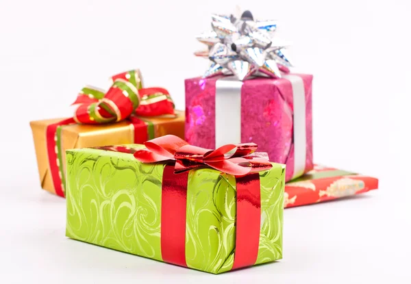 A pile of Christmas gifts in colorful wrapping with ribbons — Stock Photo, Image