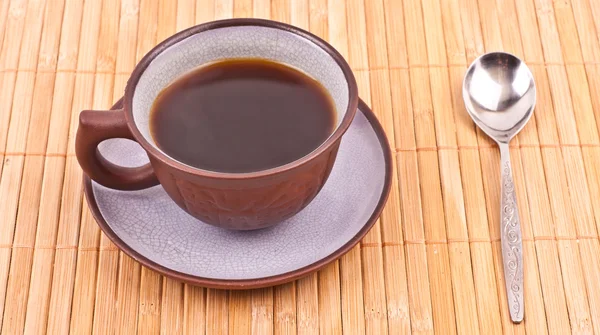 Cup of coffee on the bamboo placemat — Stock Photo, Image