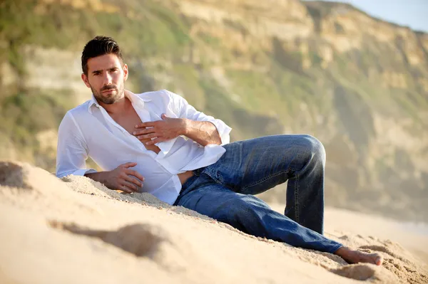 Muscular model posing on beach Stock Photo by ©AY_PHOTO 106353890