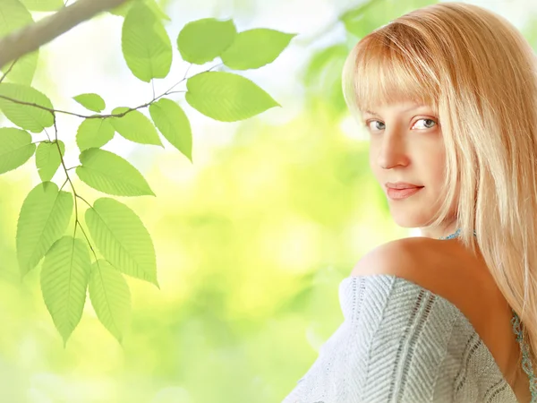 Young blond woman in the spring garden — Stock Photo, Image