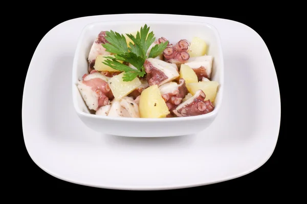 Octopus with potatoes served in a white dish — Stock Photo, Image