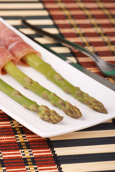 stock image Steamed asparagus and raw ham