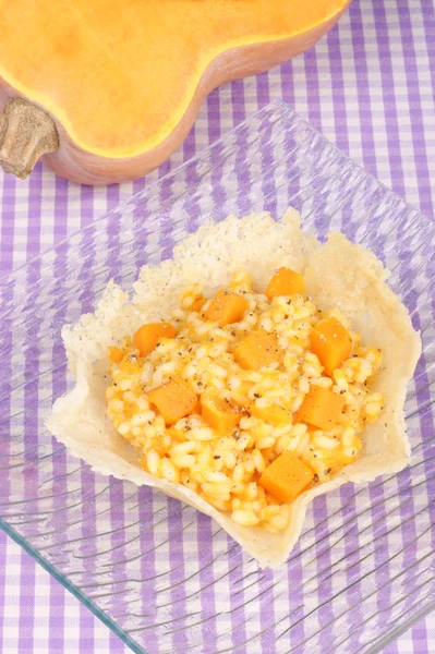Risotto with pumpkin in a cheese basket — Stock Photo, Image