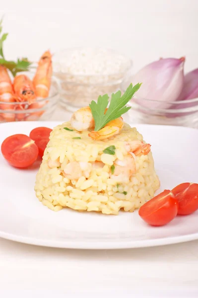 Risotto with shrimps served on a white plate