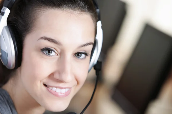 Мила ділова служба обслуговування клієнтів жінка посміхається, комп'ютер на форграмі — стокове фото